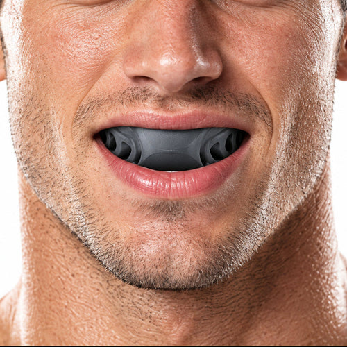 Man biting down on the jaw trainer